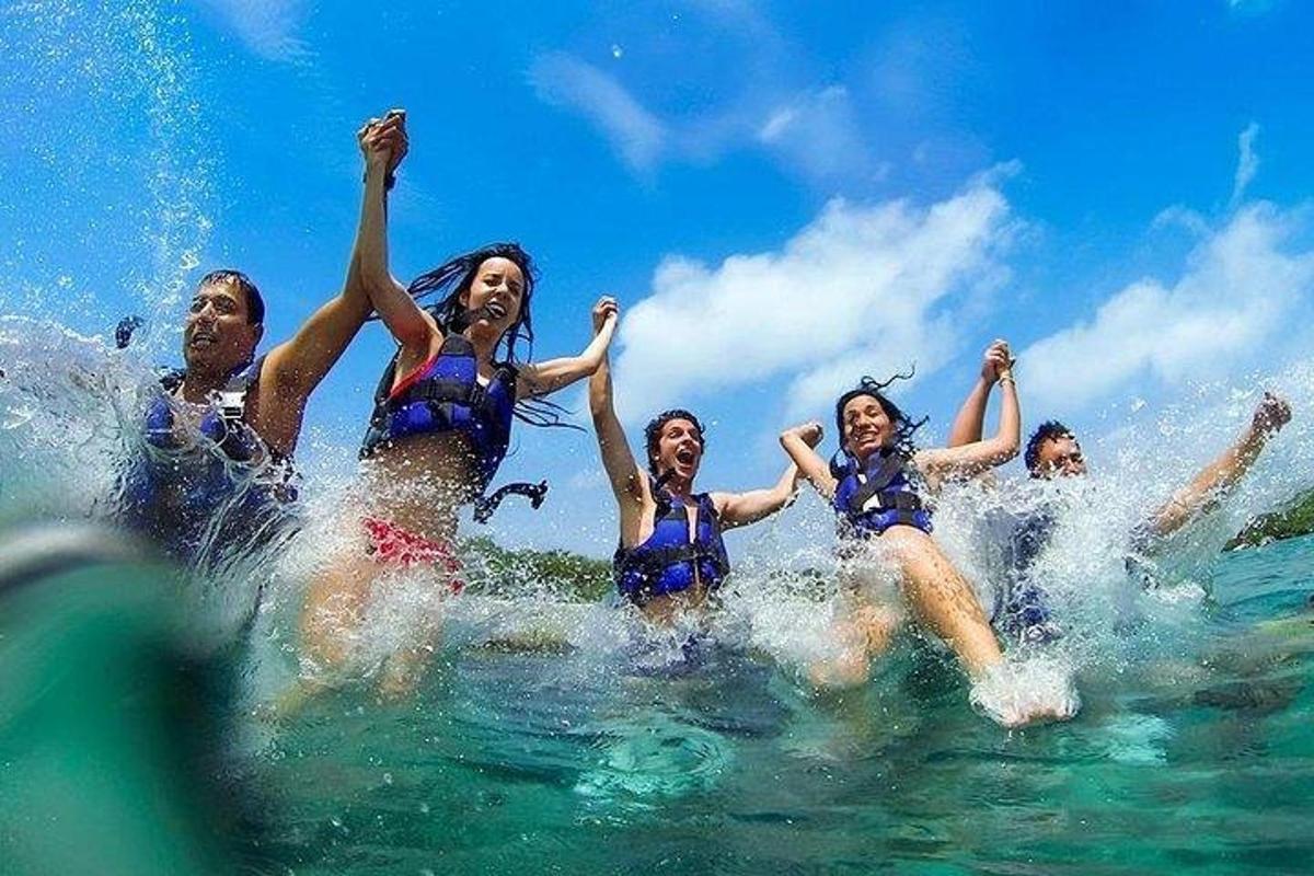 a group of people jumping in the water