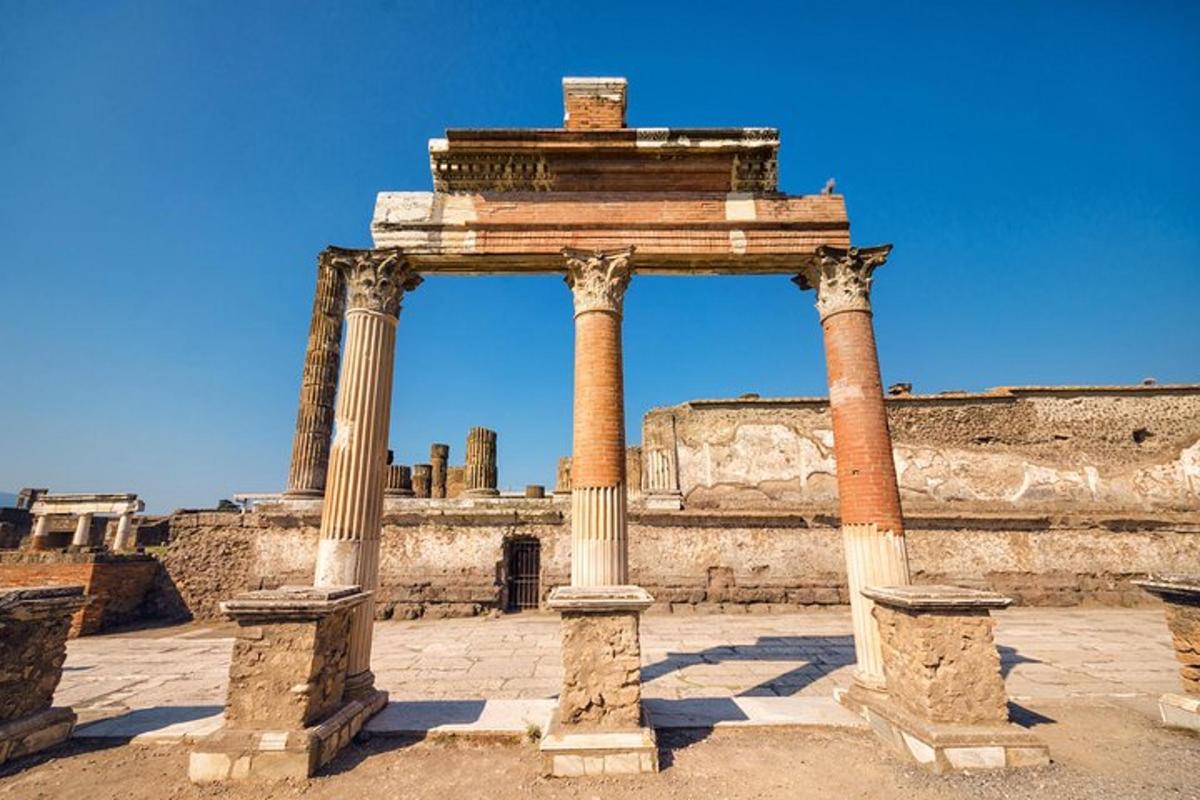 an ancient temple with two columns in front of a building