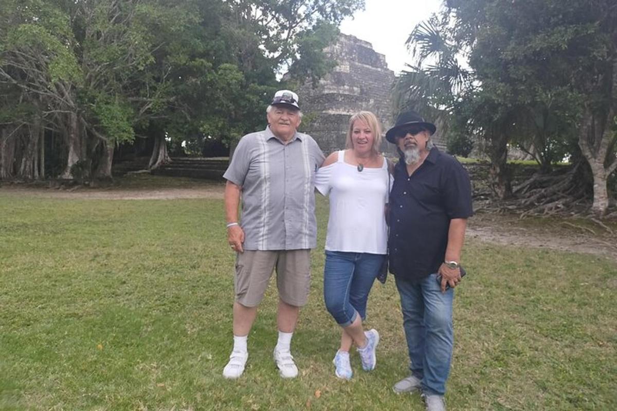 a group of three people standing in a field