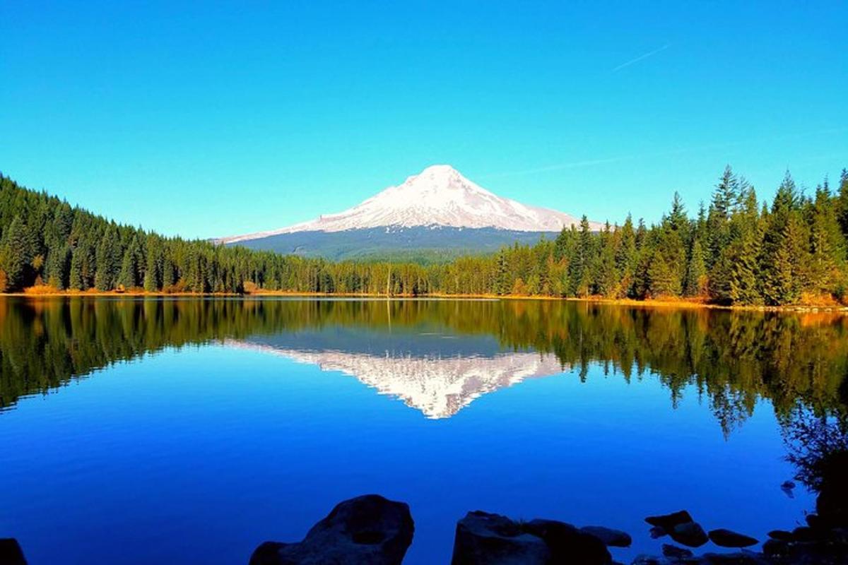 a mountain reflection in a lake with a mountain in the background