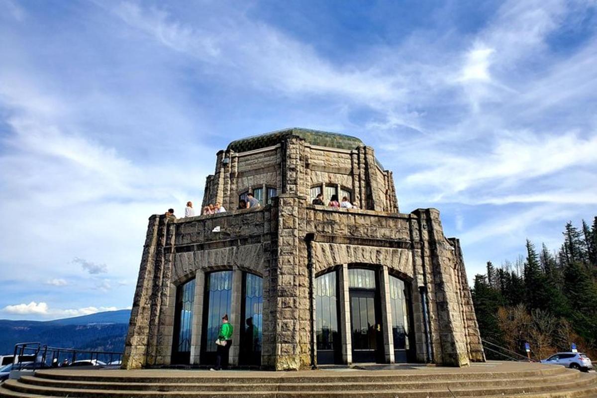 a stone building with people standing on top of it