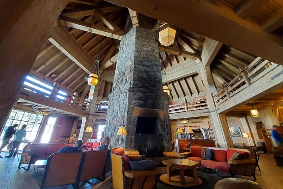 a living room with a stone fireplace in a building