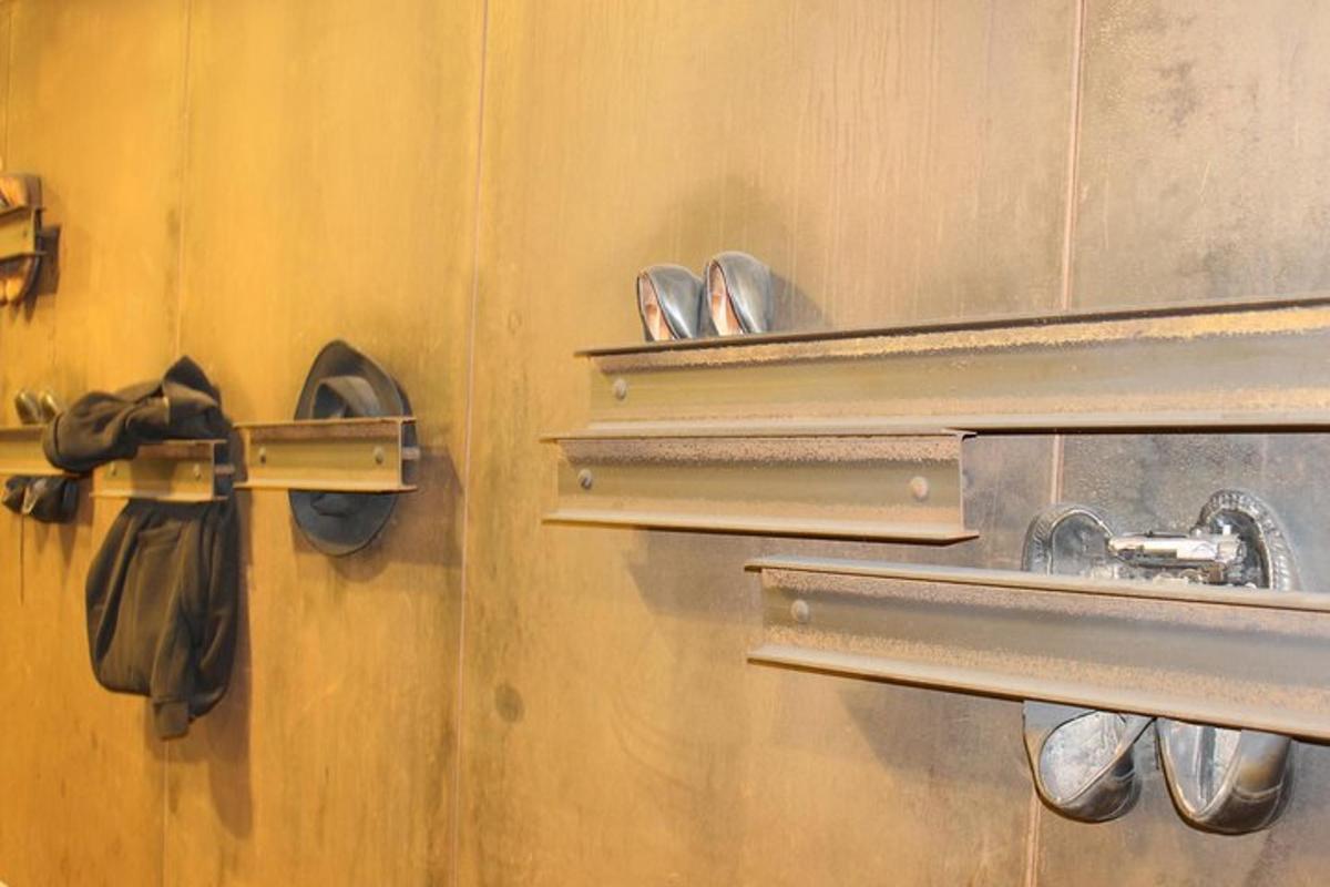 a room with a door with hooks and shoes