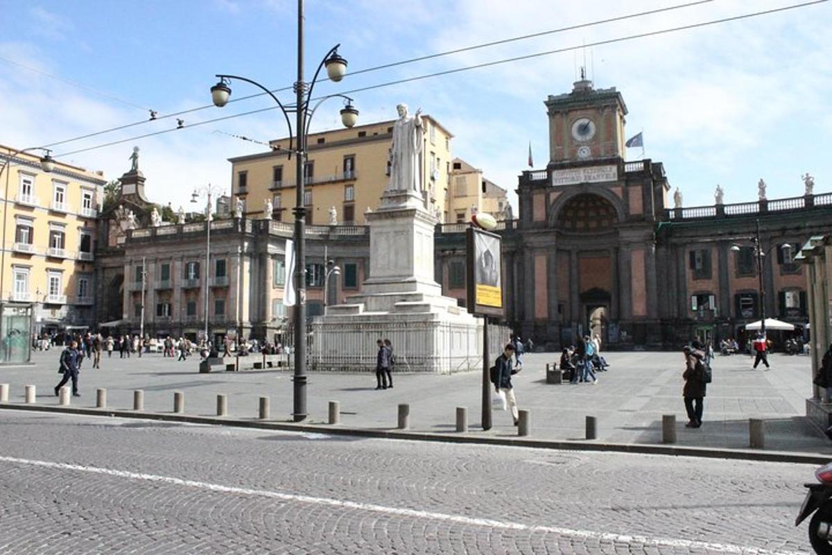 a city street with a clock tower in front of a building