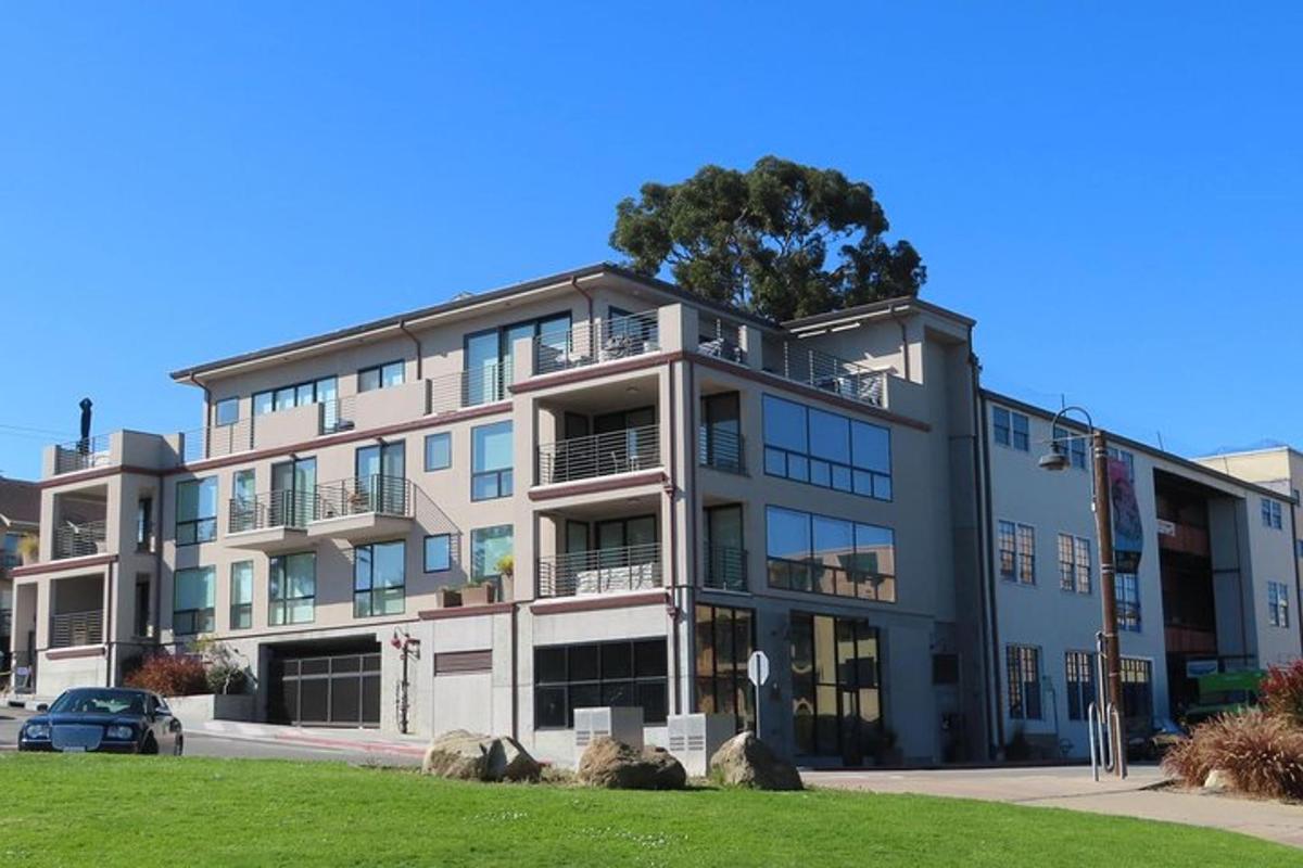 an apartment building with a tree on top of it