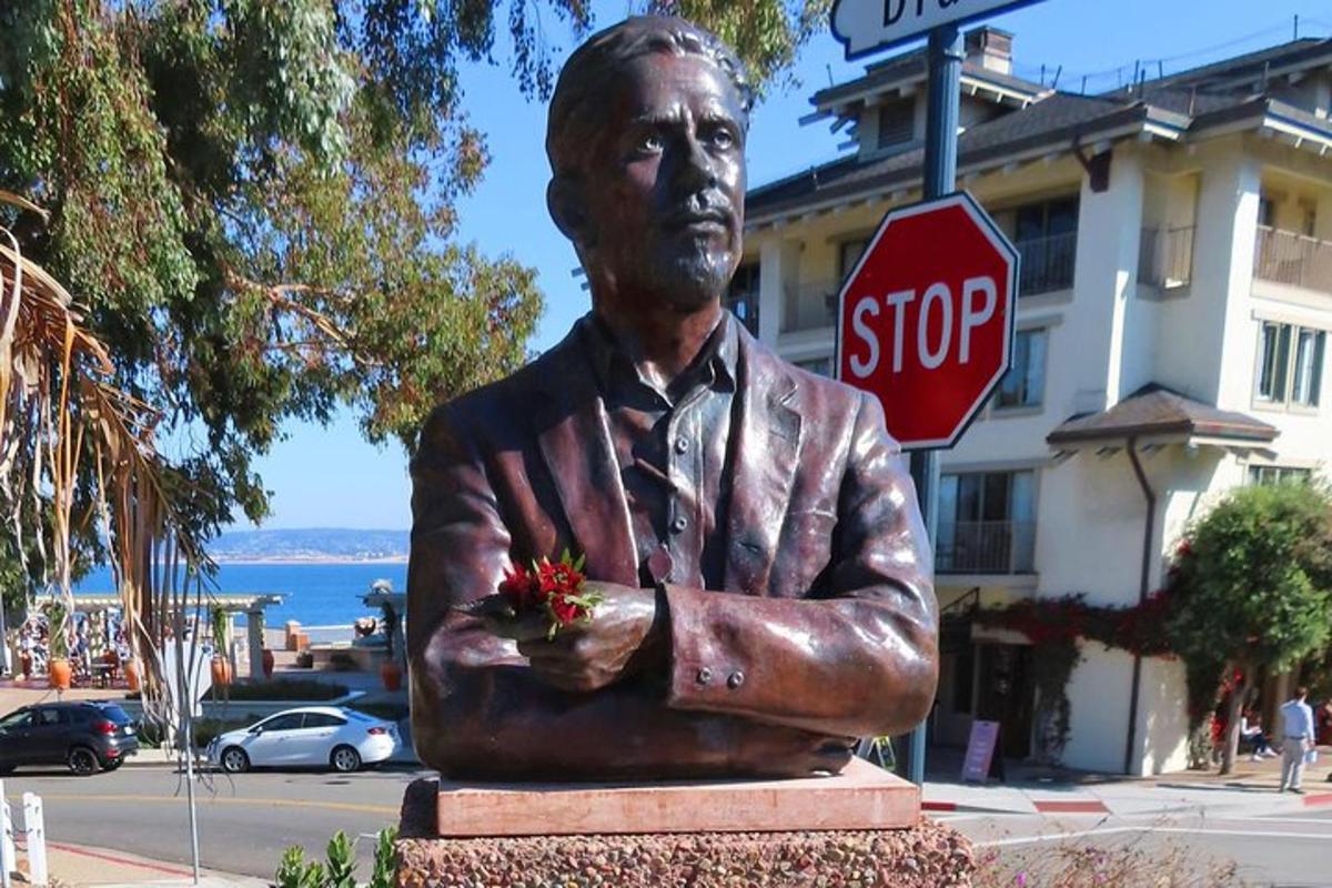 a statue of a man holding a bunch of flowers