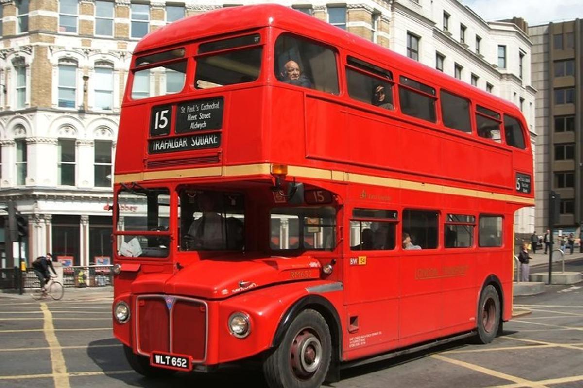 a red double decker bus driving down a street
