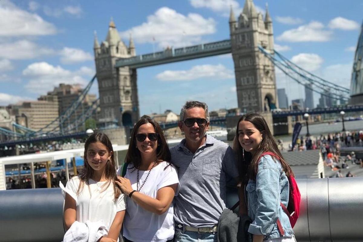 a group of people standing in front of the tower bridge