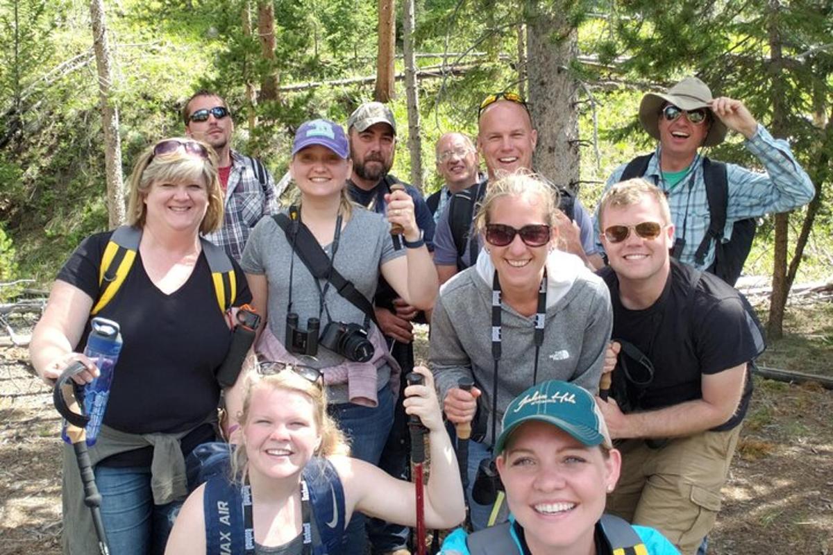 a group of people posing for a picture on a trail