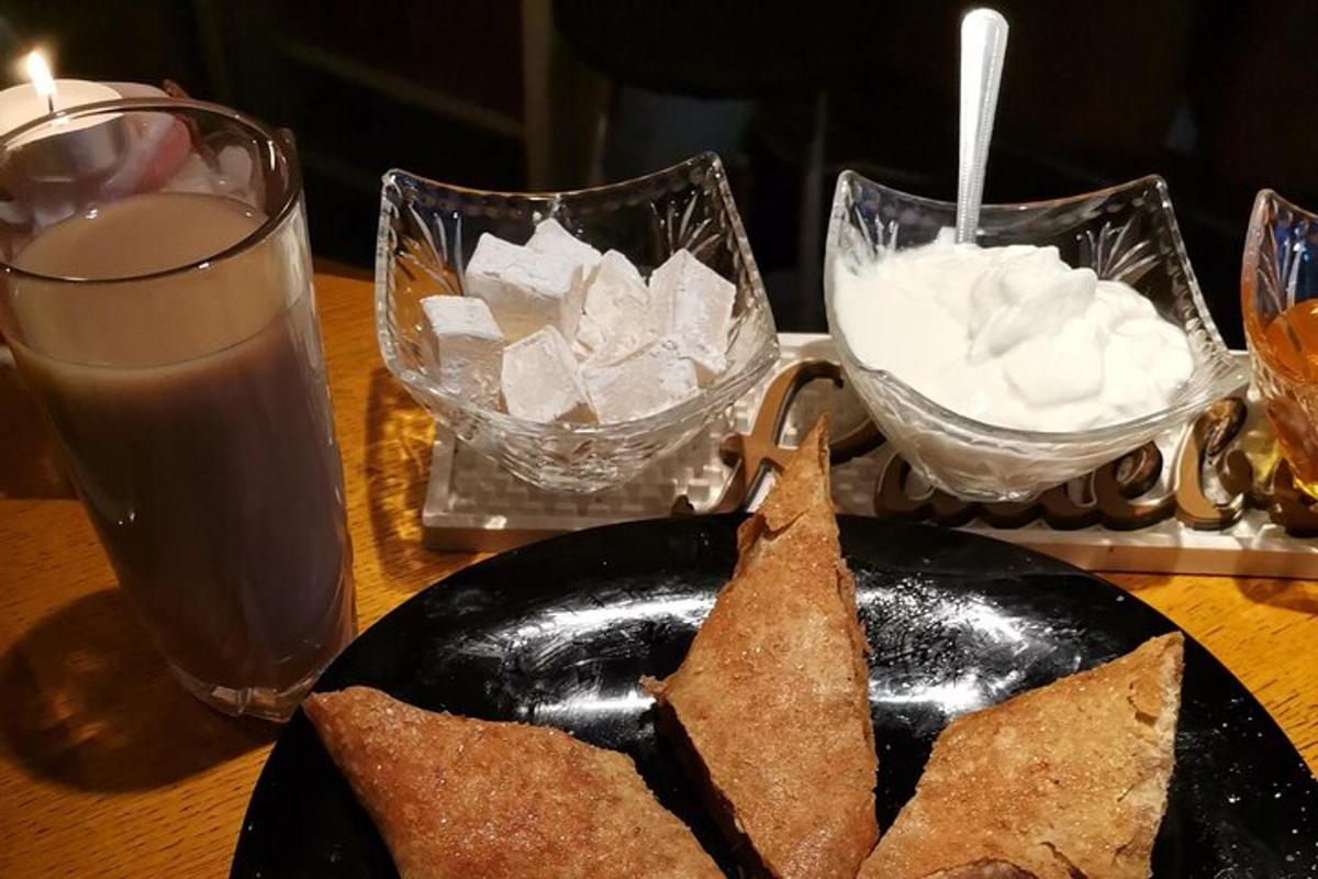 a table with a plate of food and a glass of water