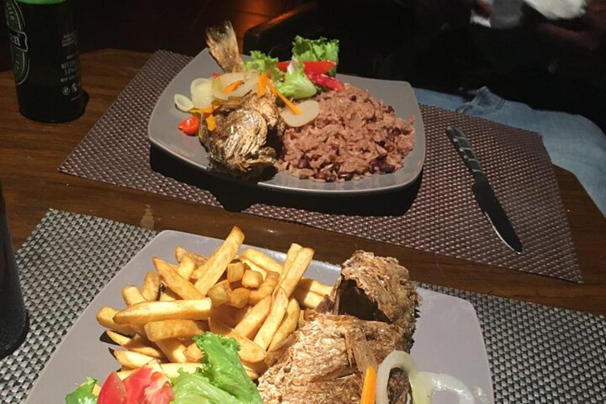 two plates of food and french fries on a table