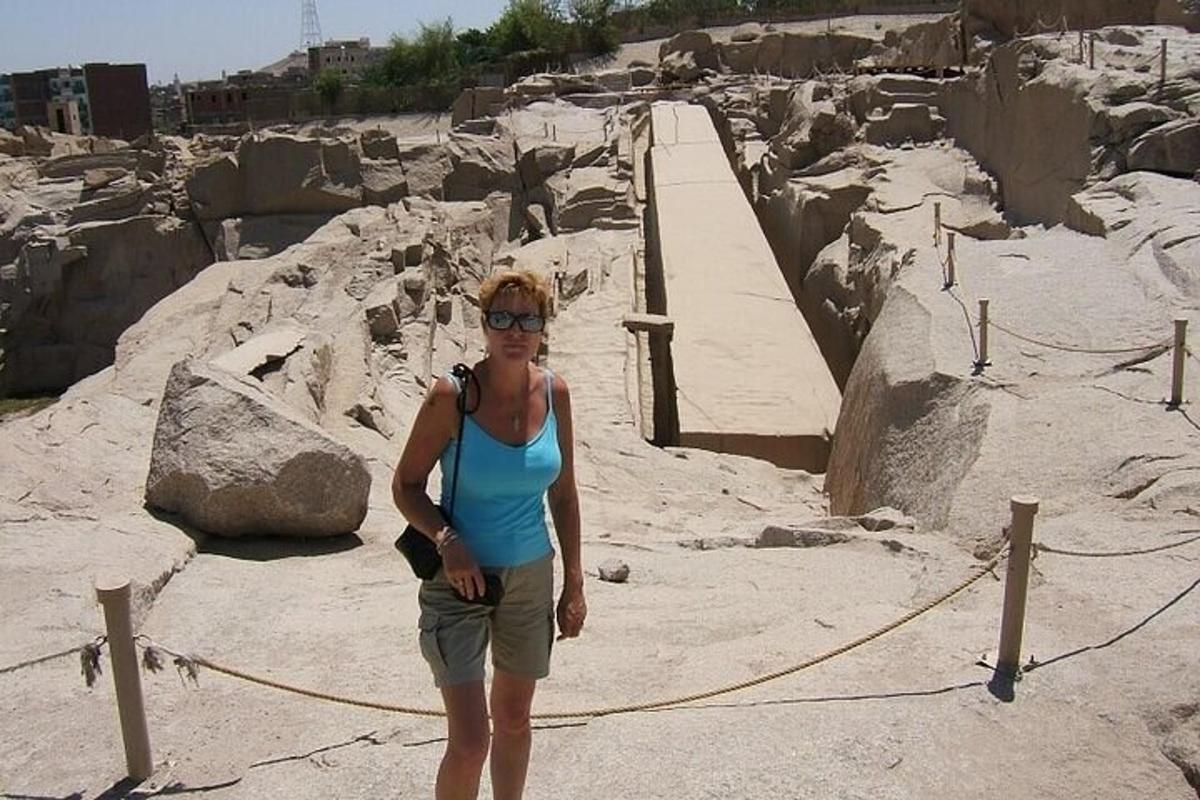 a woman standing in front of a rock formation
