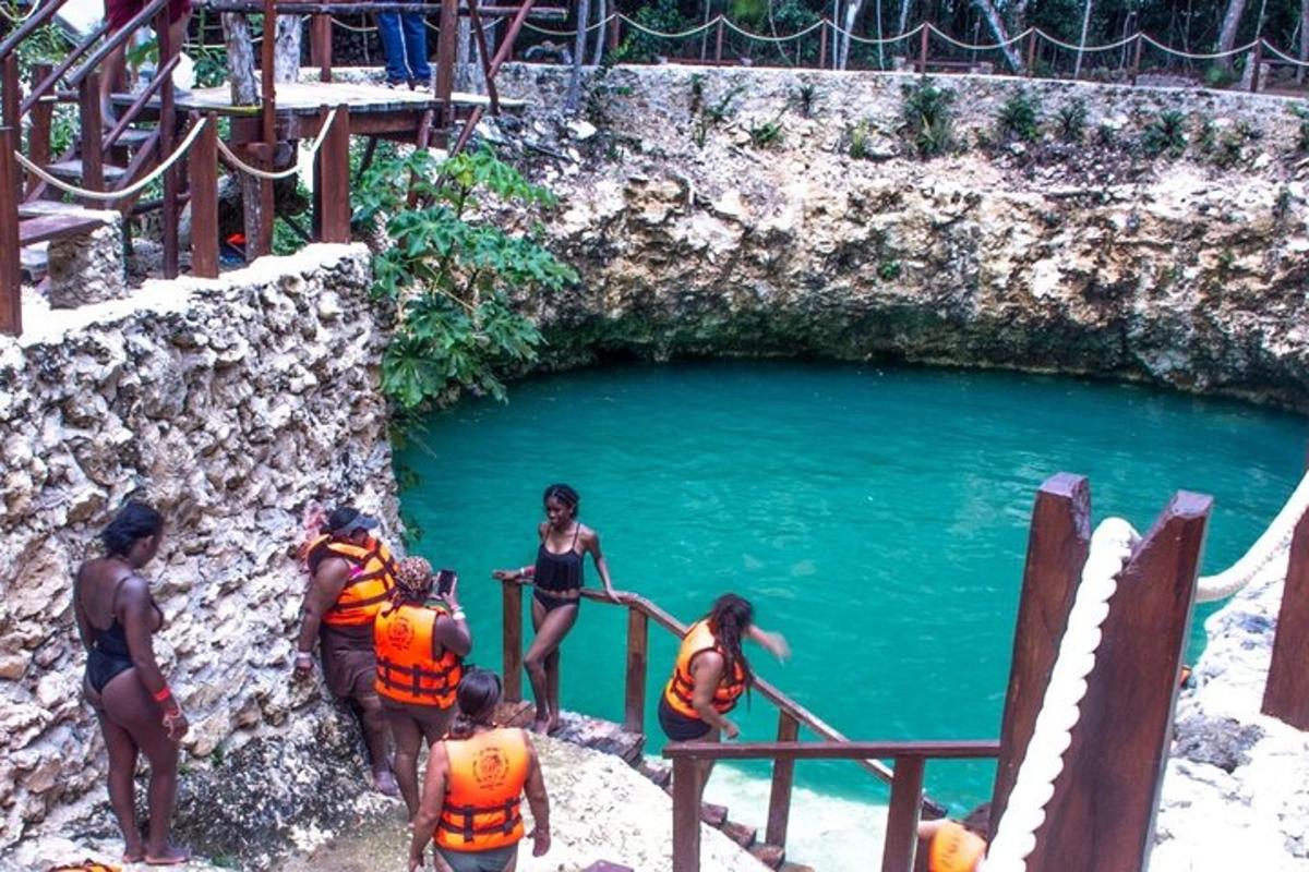 a group of people standing around a pool of water