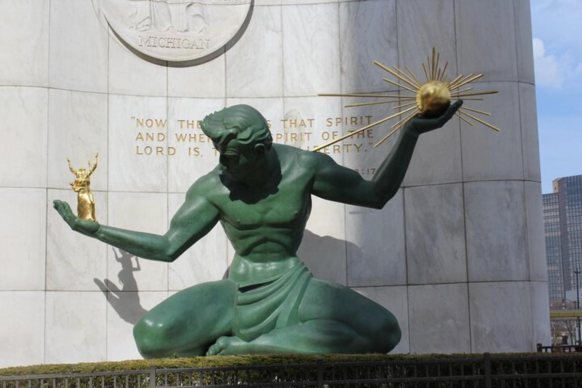 a statue of a green man holding a ball