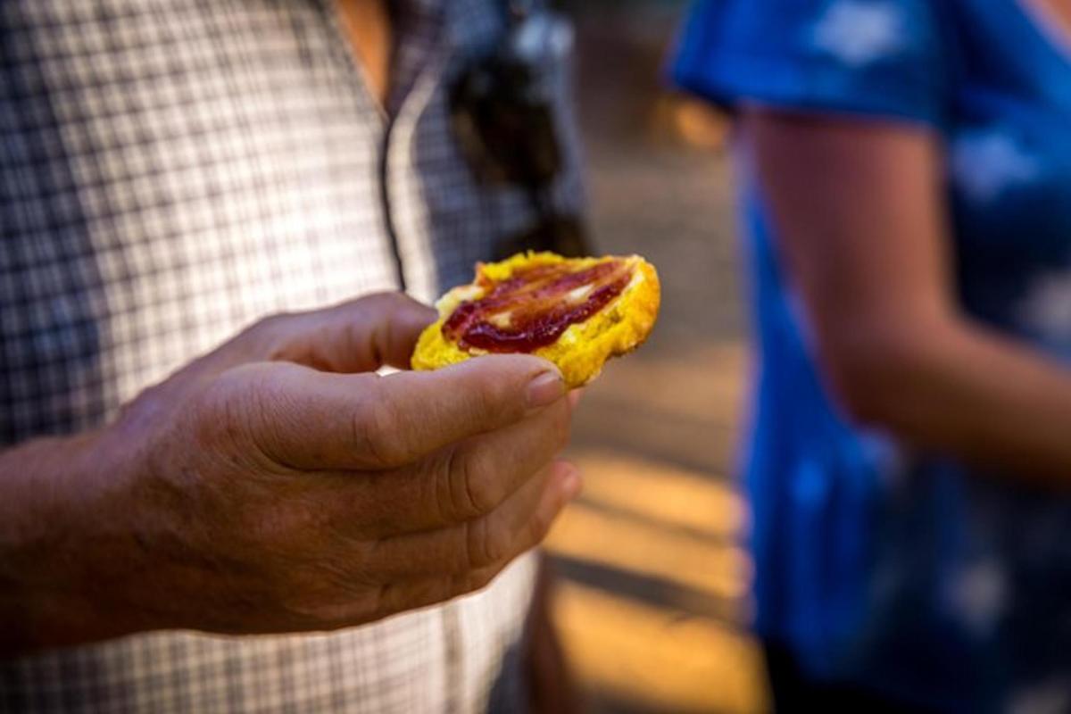 a man holding a piece of food in his hand