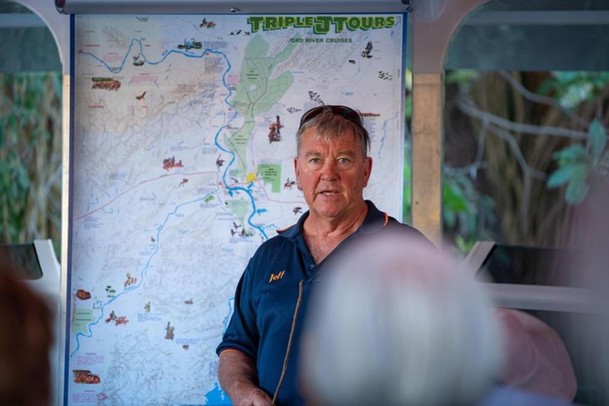 an older man standing in front of a map
