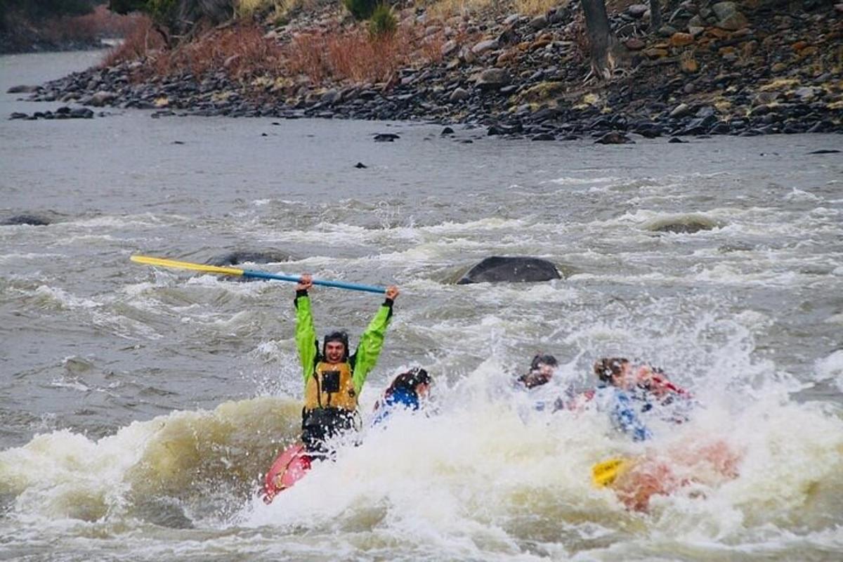 a group of people on a raft in a river