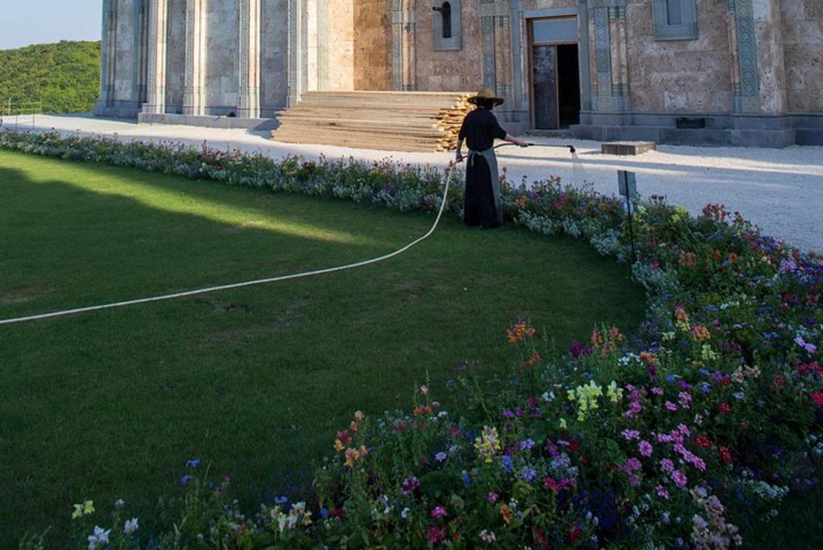 a woman is pulling a rope in a garden