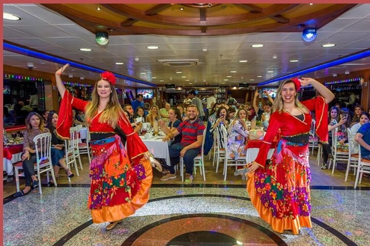 two women dancing at a party in front of a crowd