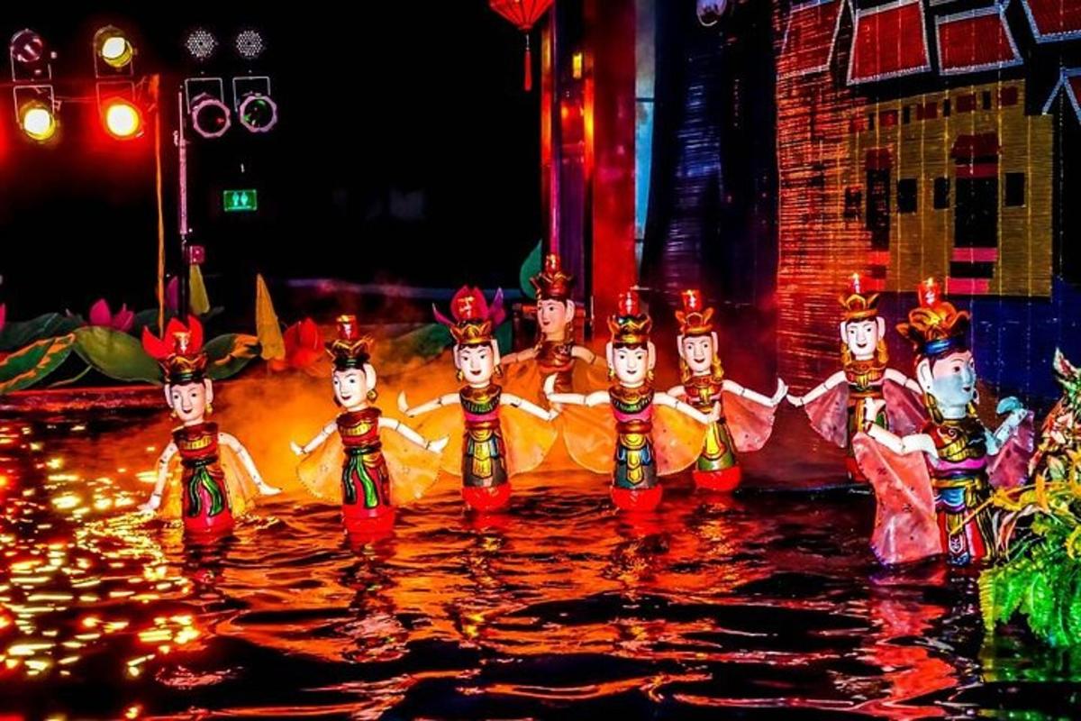a group of people dancing in the water at night