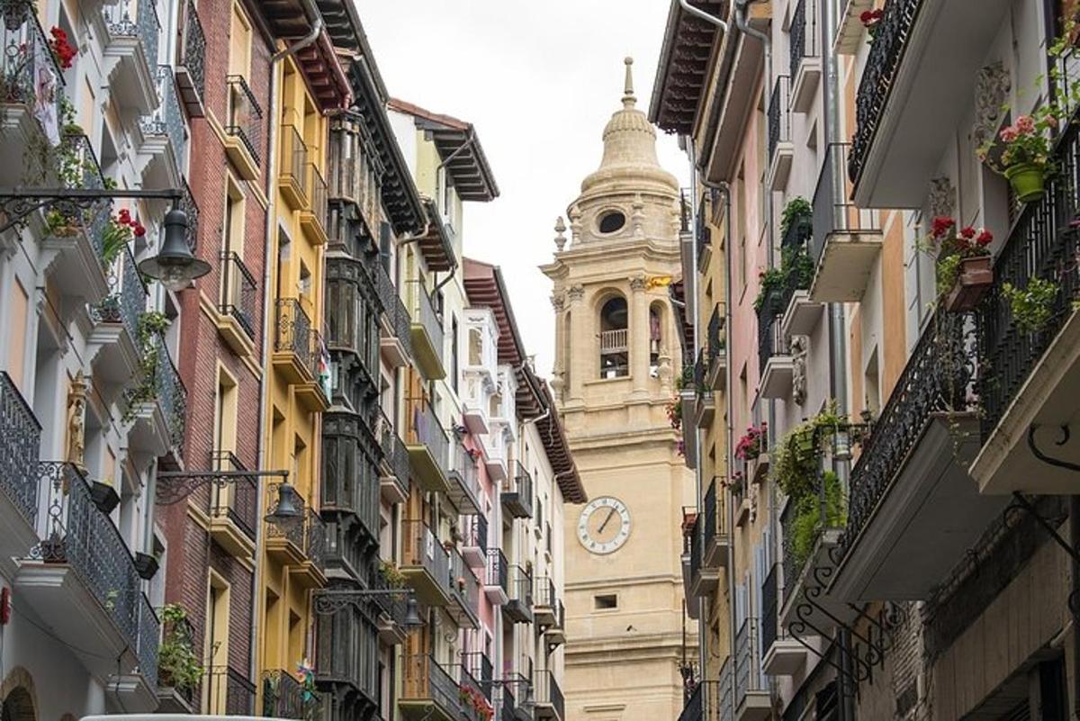 a tall building with a clock tower in a street