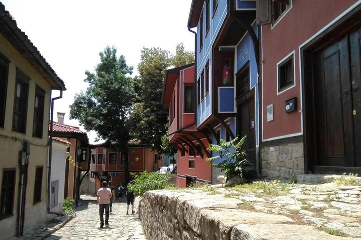 a group of people walking down a street next to buildings