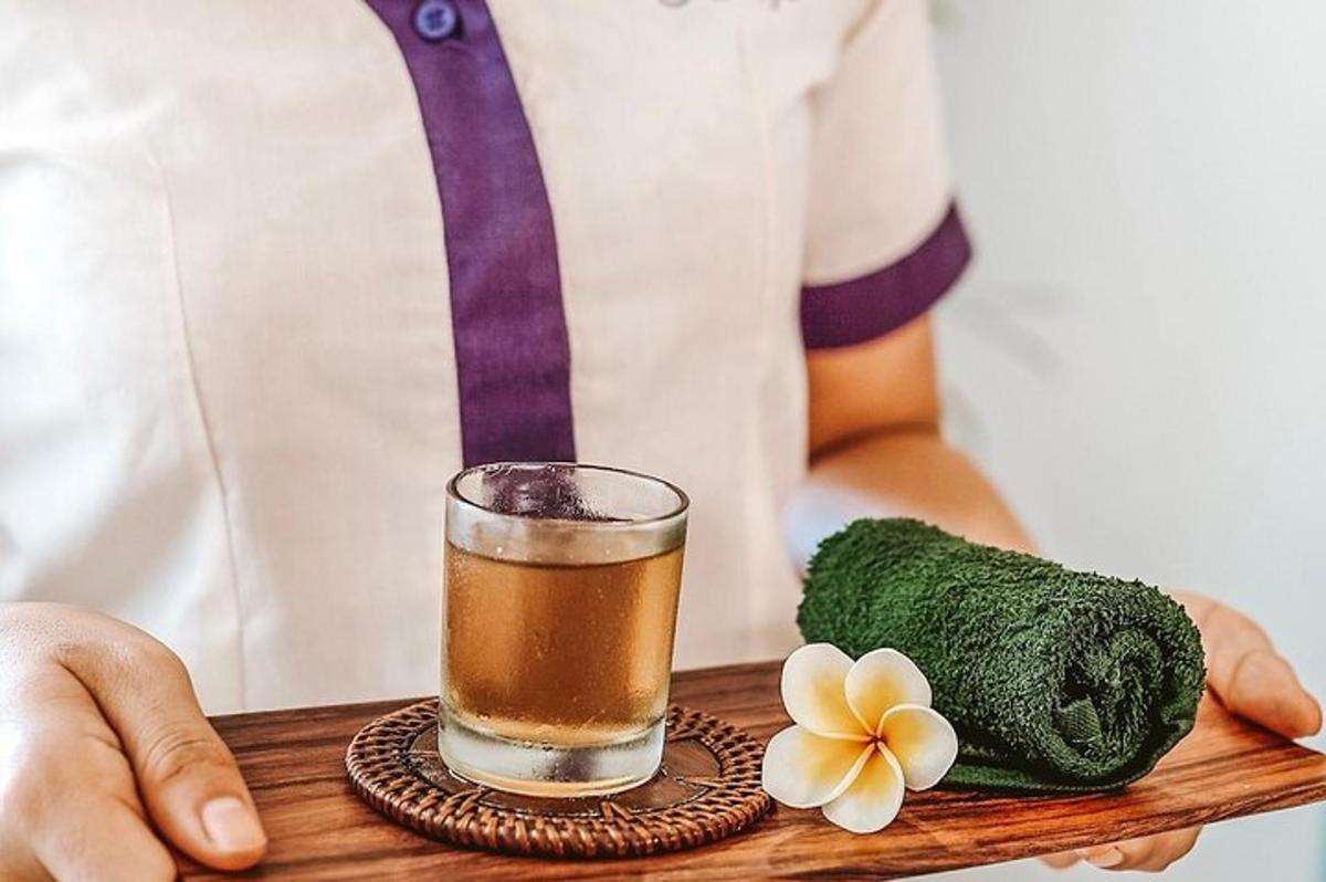 a person holding a tray with a drink and a flower