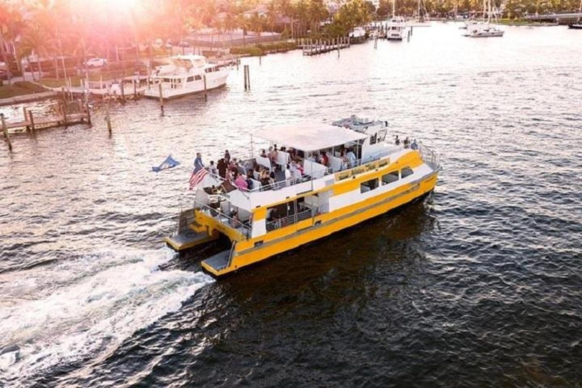 a yellow boat with people on it in the water
