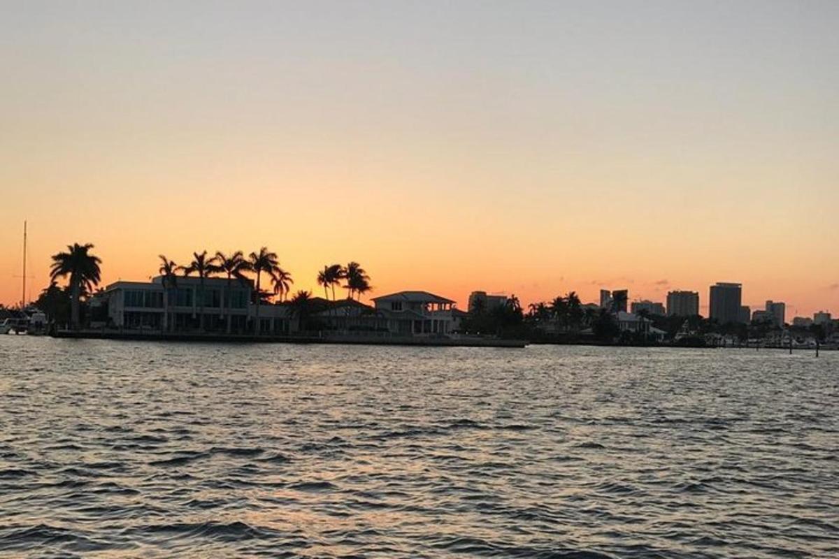 a view of a city from the water at sunset