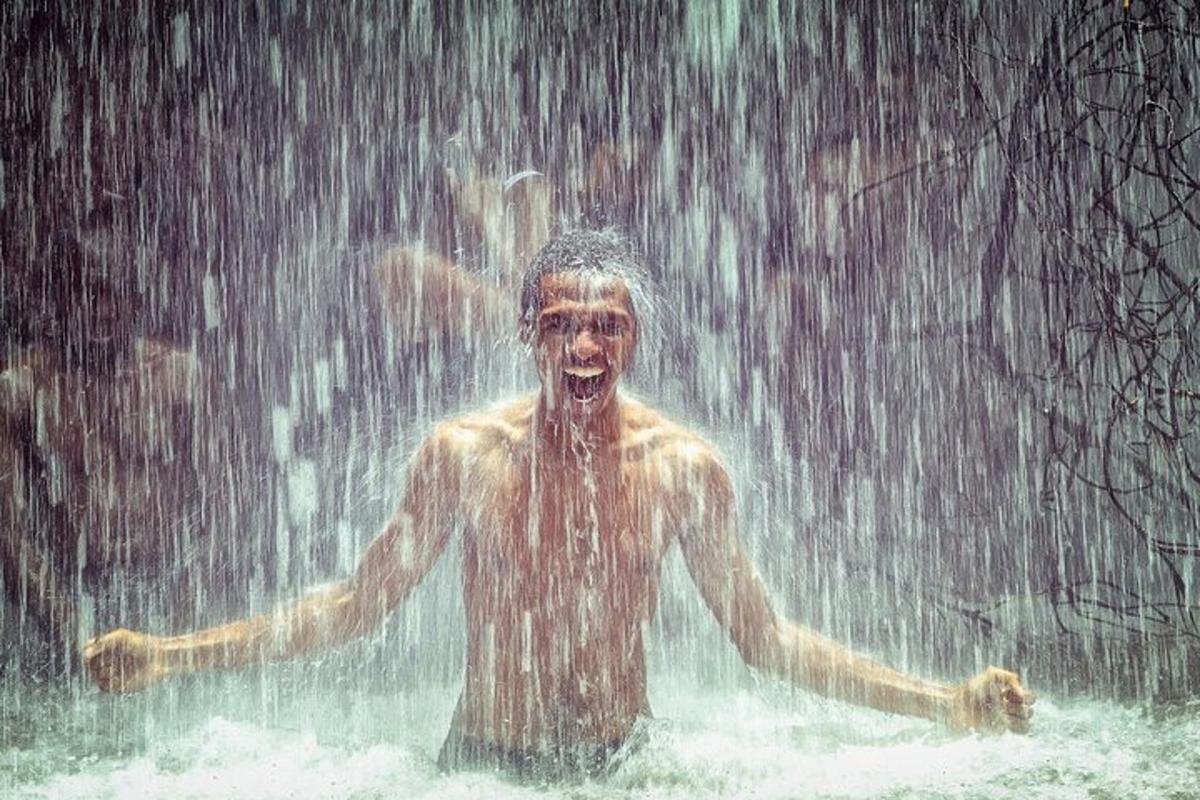 a man standing in the water in the rain