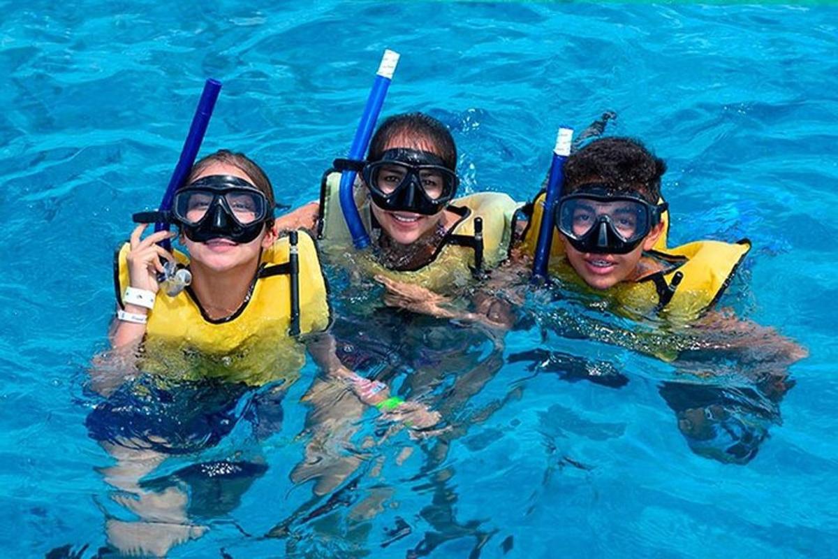 three people in the water with snorkelling equipment