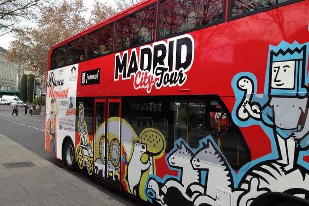 a red double decker bus with graffiti on it