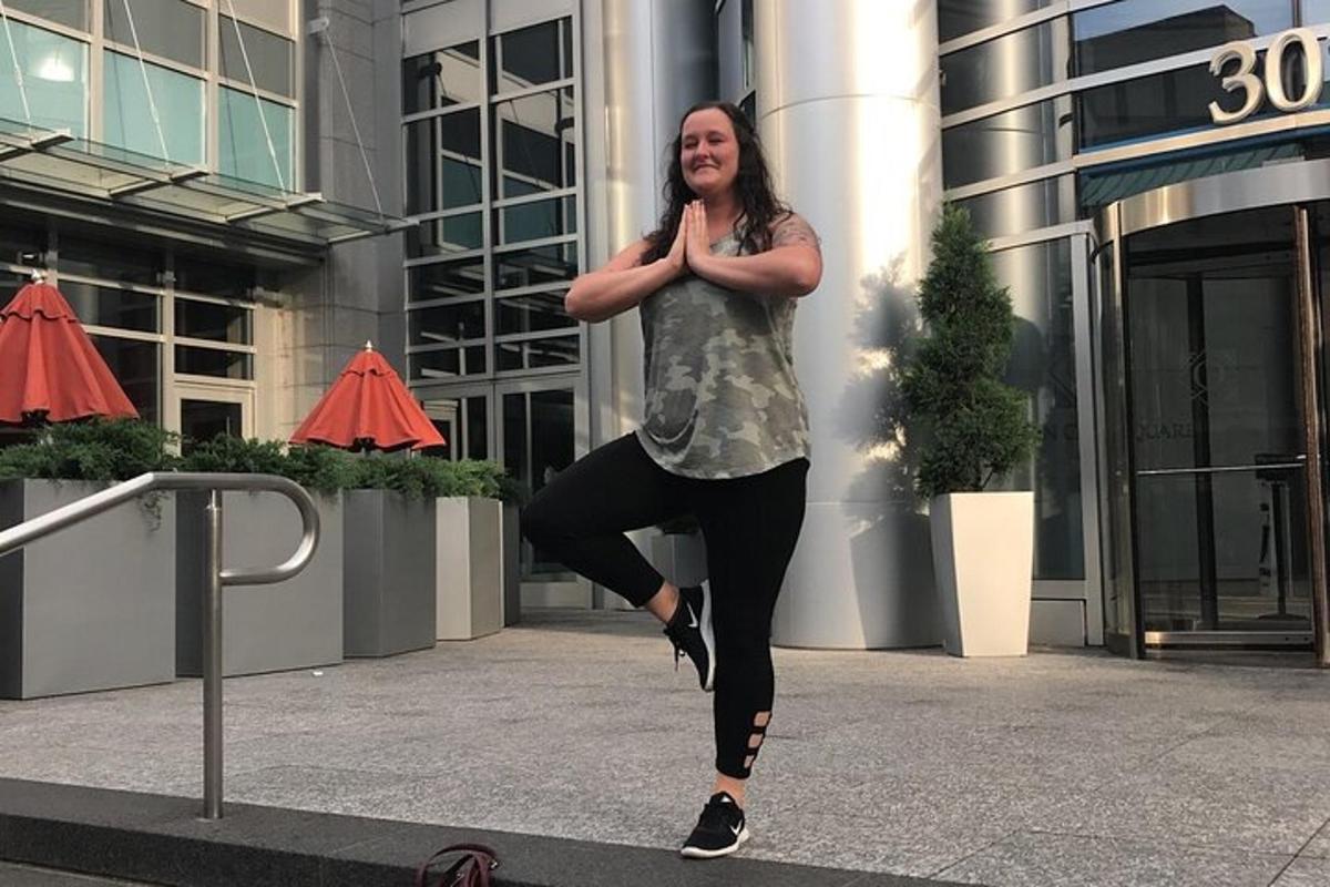 a woman is doing yoga in front of a building