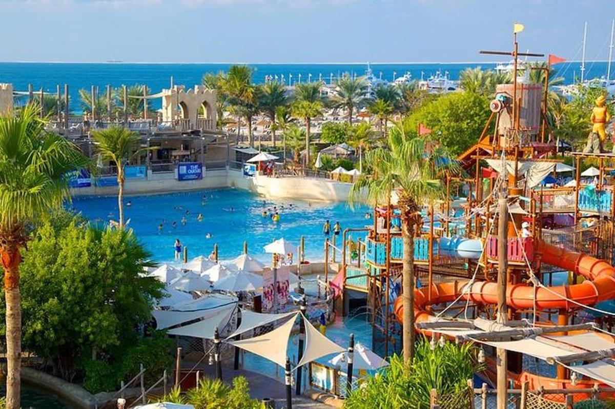 a large pool with a water park with people in it