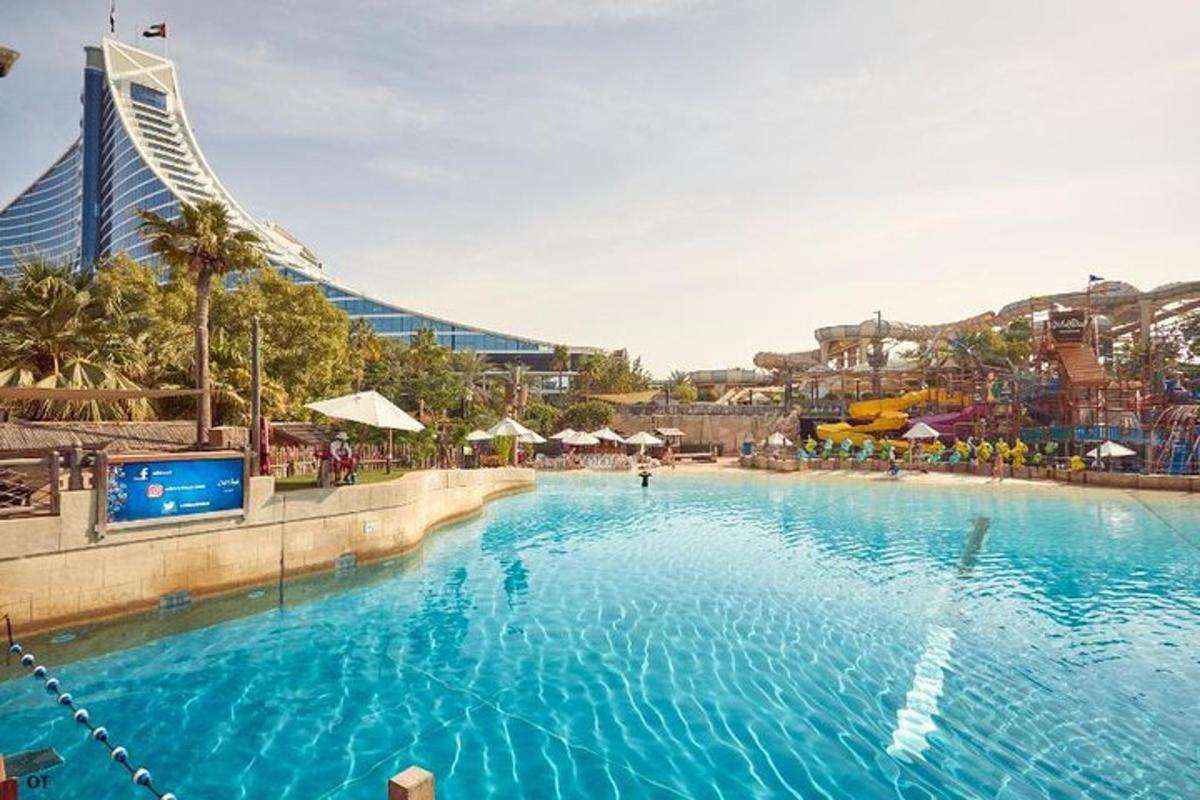 a large swimming pool with a building in the background