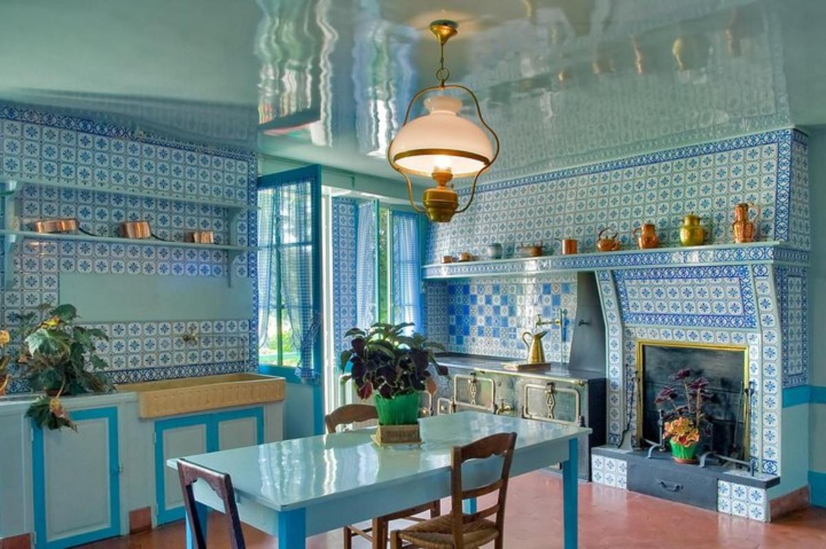 a blue kitchen with a table and a fireplace