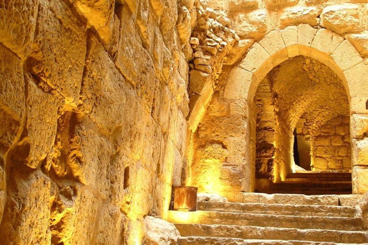 a stone building with stairs and a stone wall
