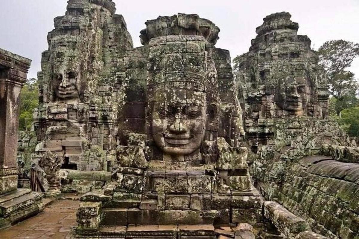 a group of stone temples with faces on them
