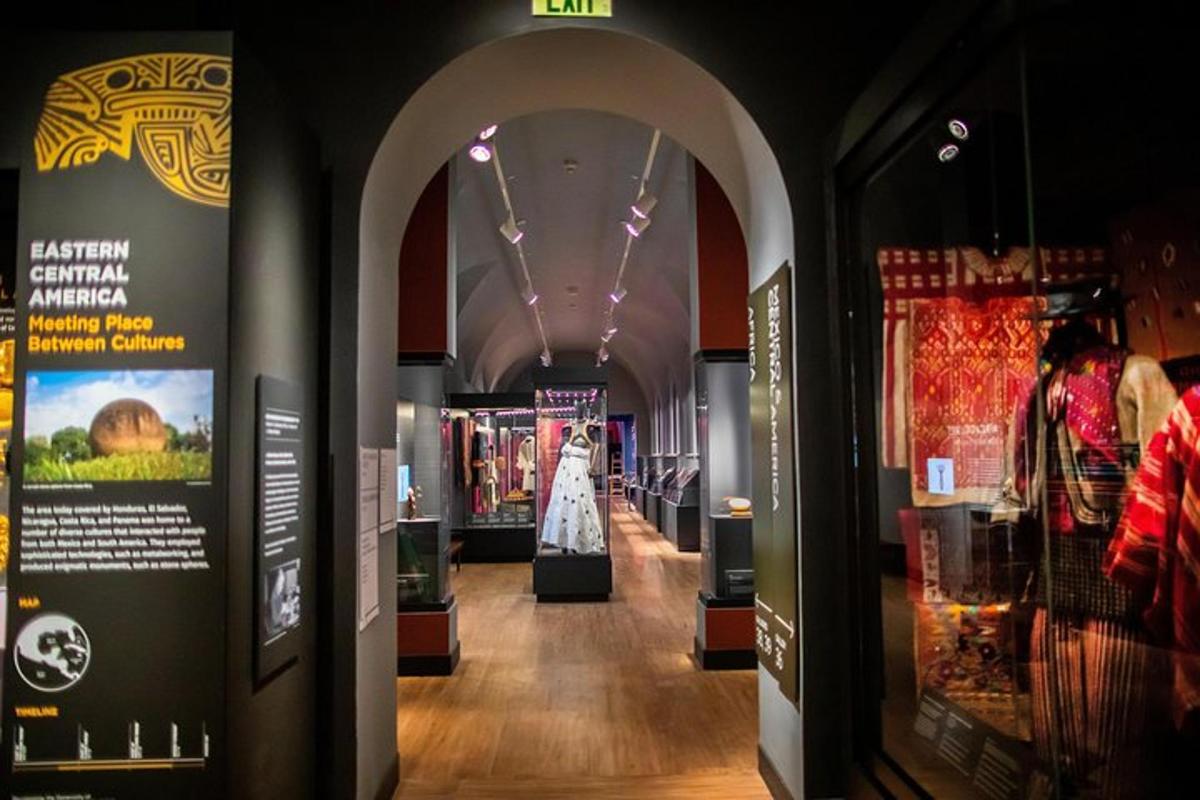 a hallway in a museum with a dress on display