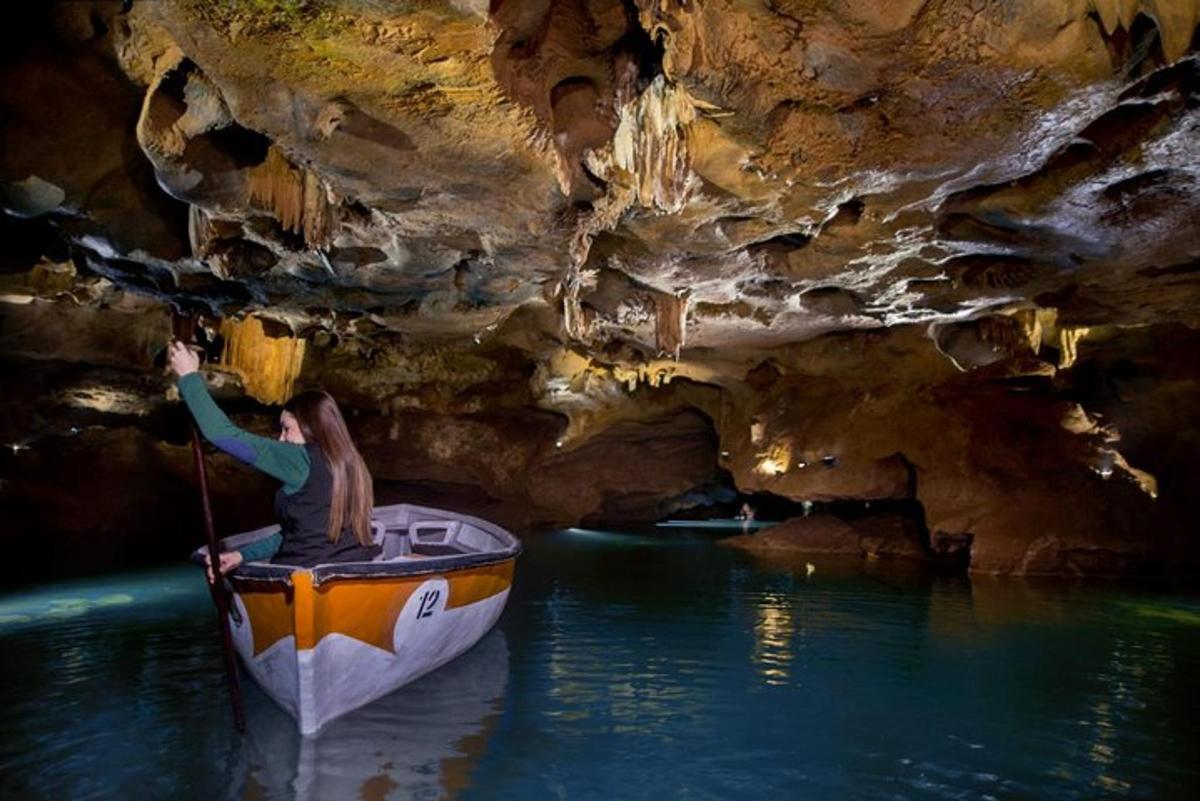 a woman in a boat in a cave