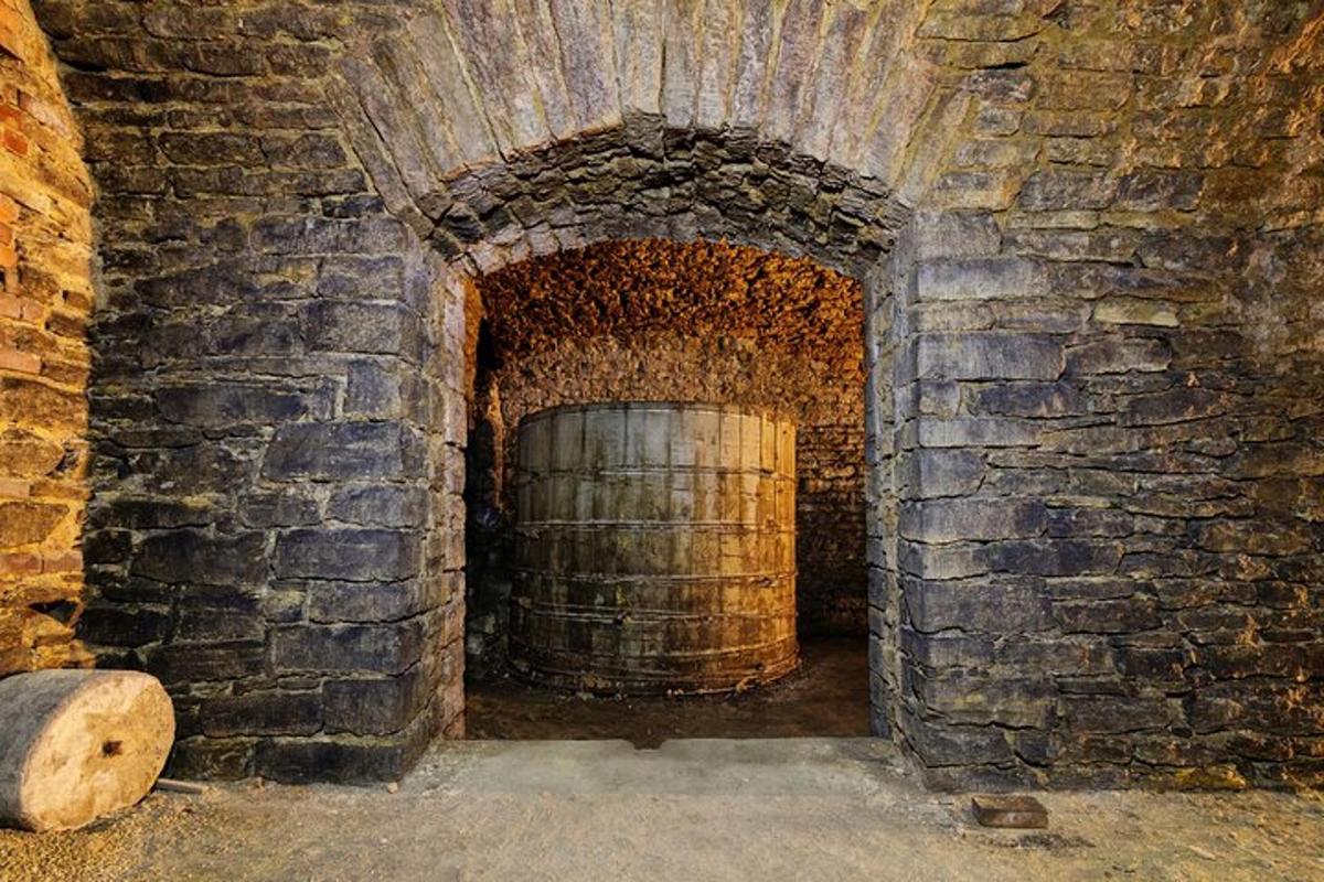 a brick tunnel with a barrel in a brick wall