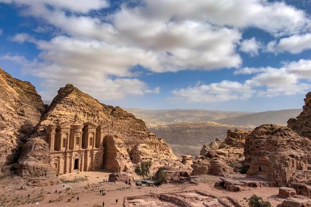 a view of a canyon with a building in the desert