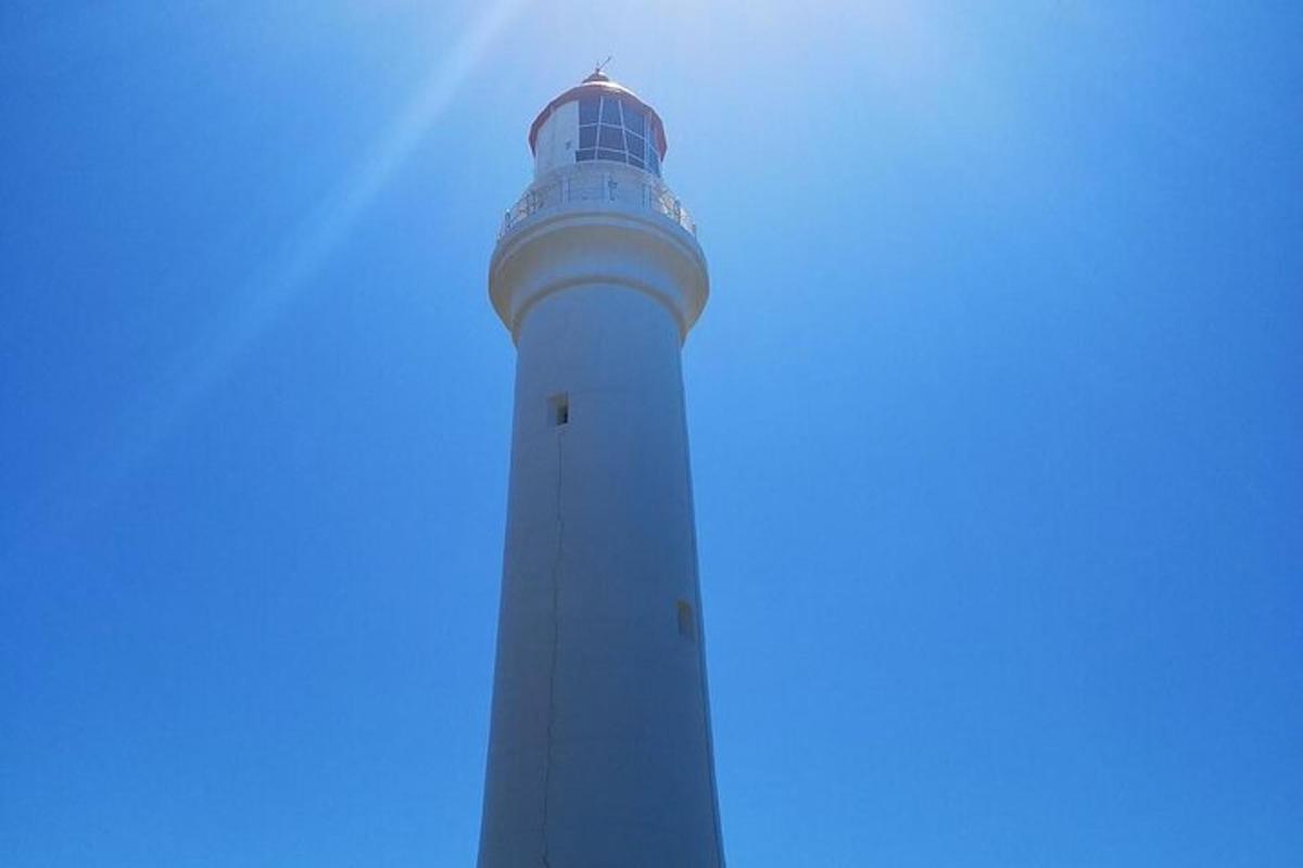 a lighthouse with a blue sky in the background