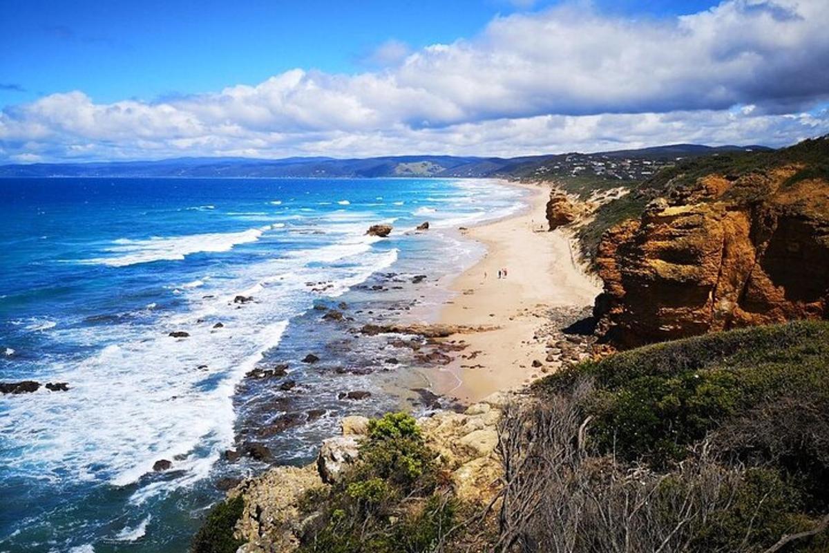 a view of a beach with people walking on it