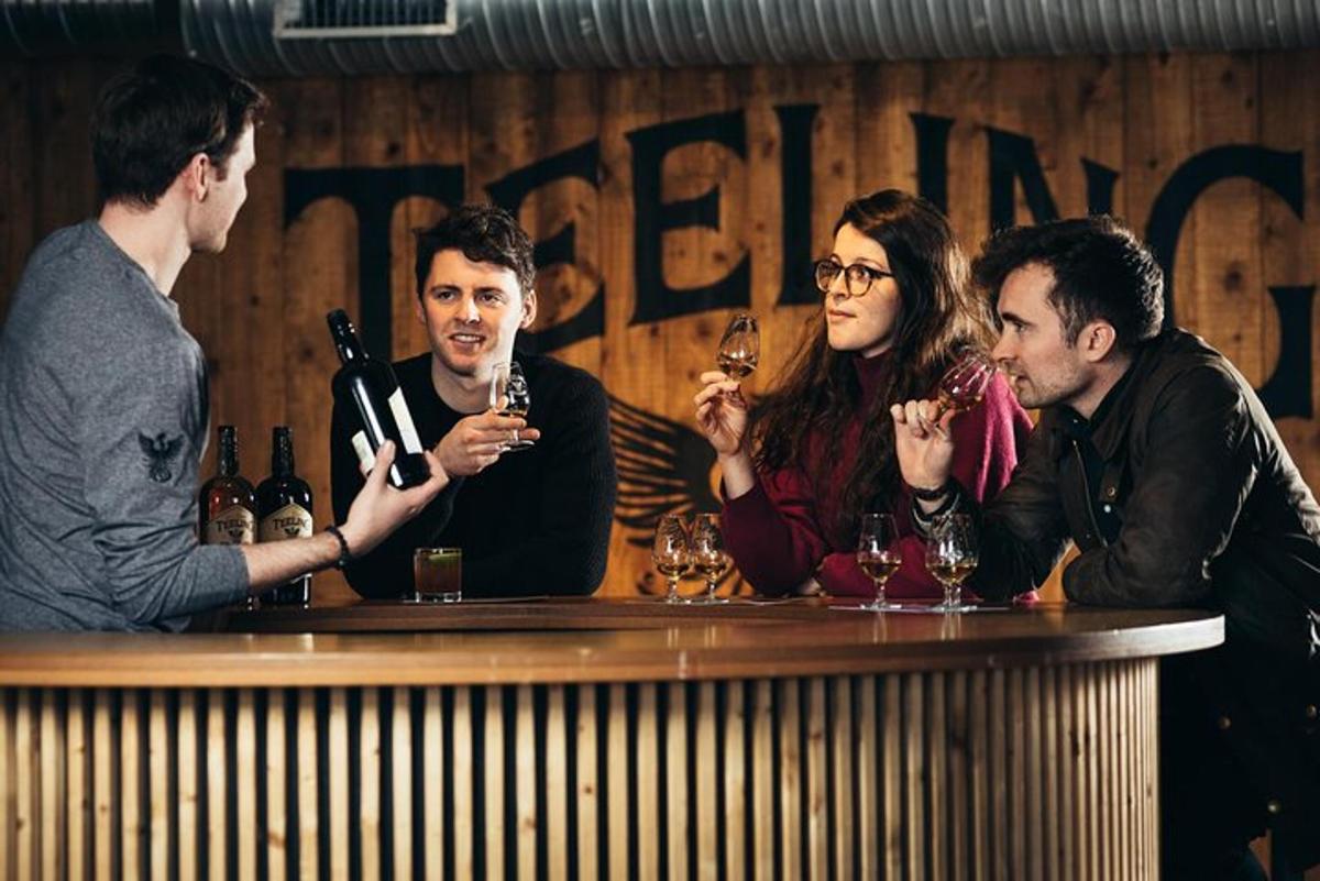 a group of people sitting at a bar drinking wine