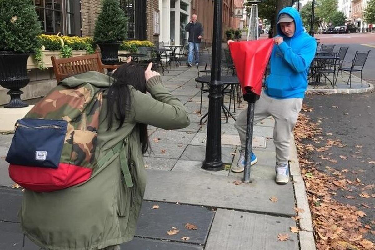 a woman is standing next to a parking meter