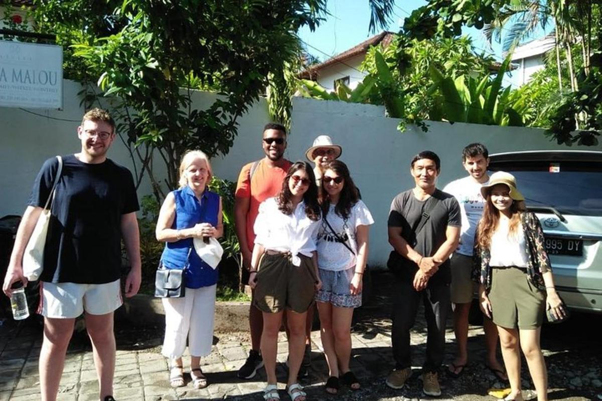 a group of people standing in front of a car