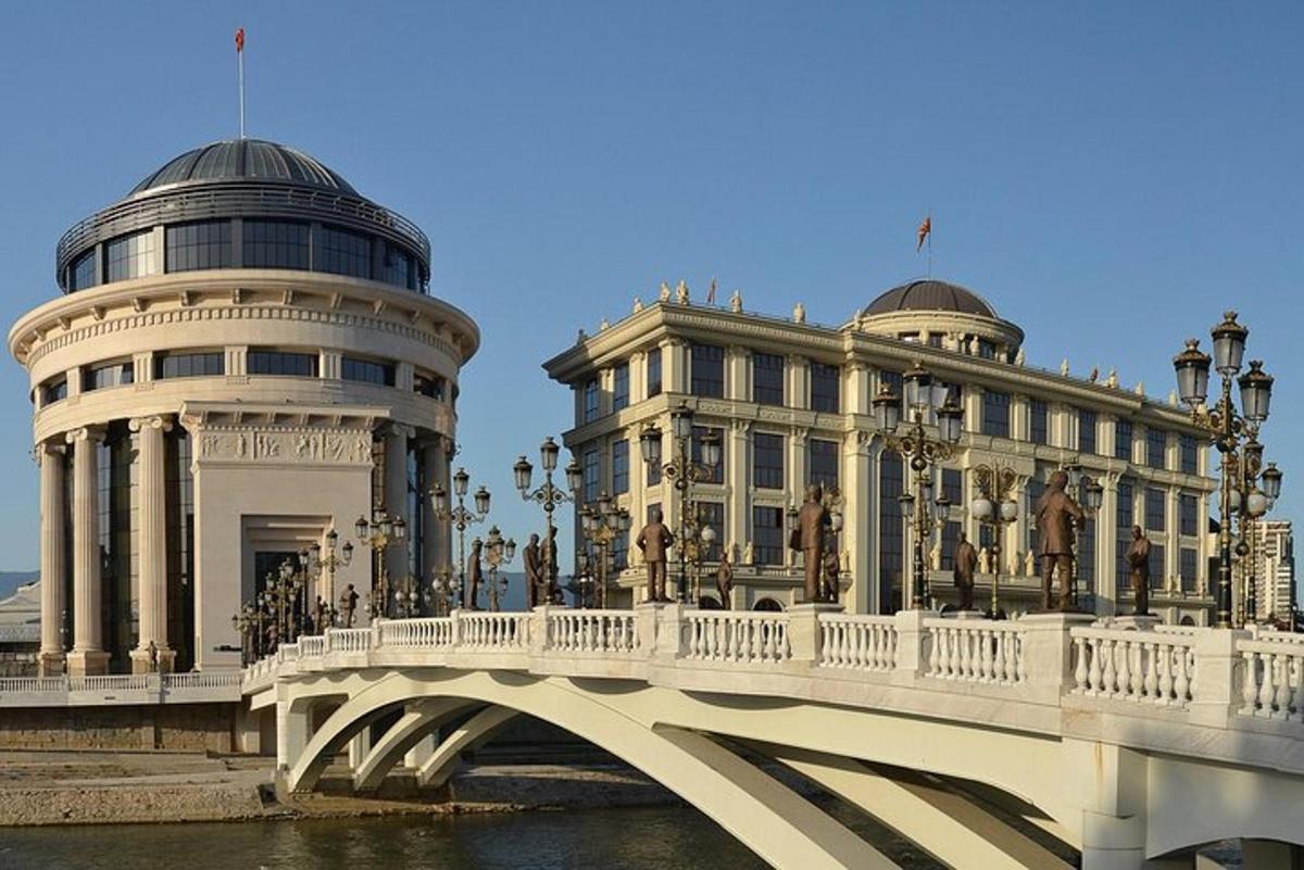 a bridge over a river in front of a building