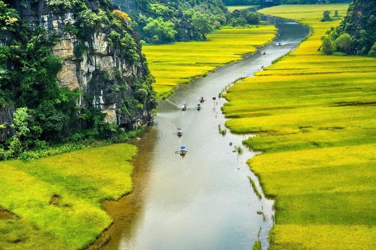 a group of people are walking down a river