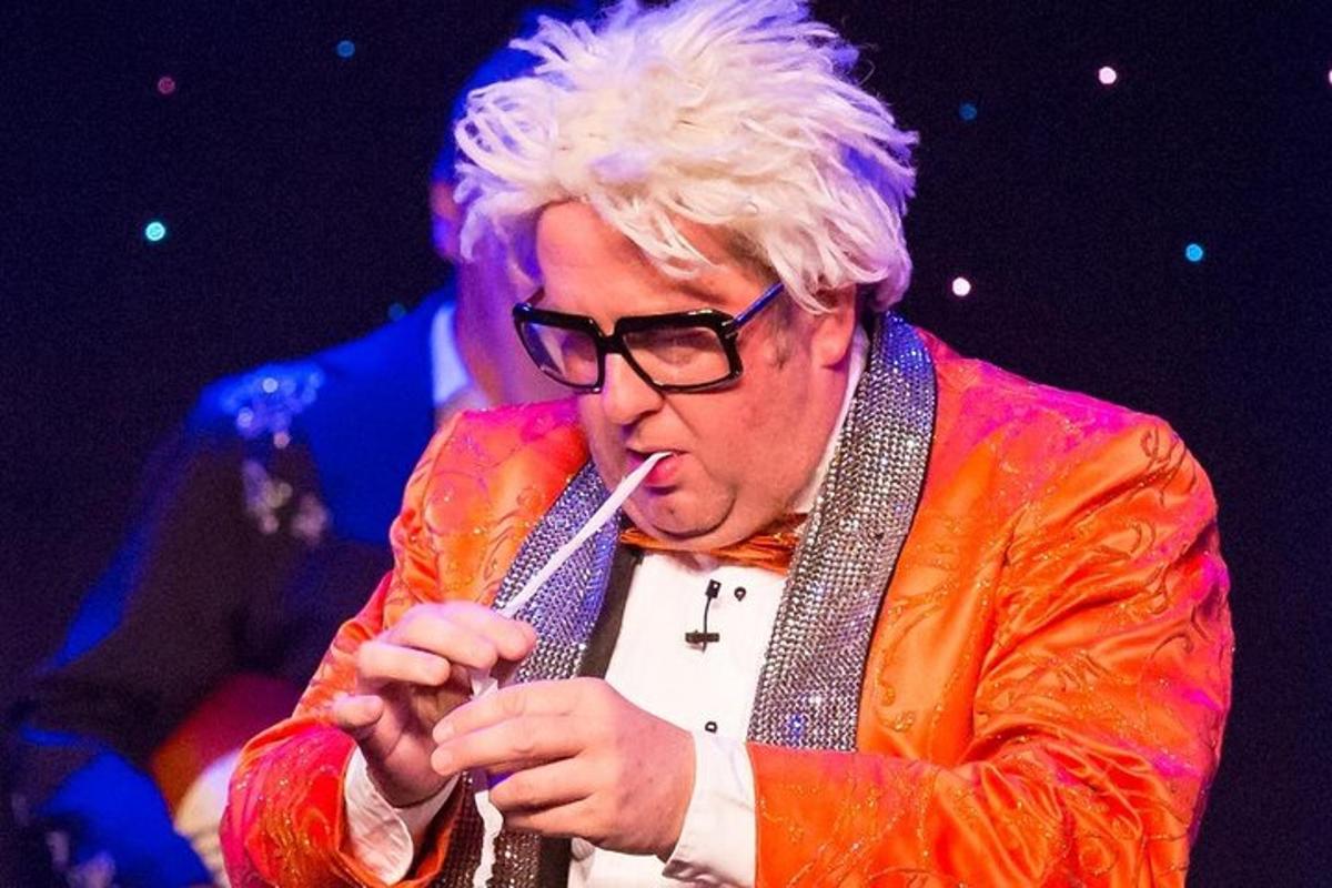 a man with white hair and glasses smoking a cigarette